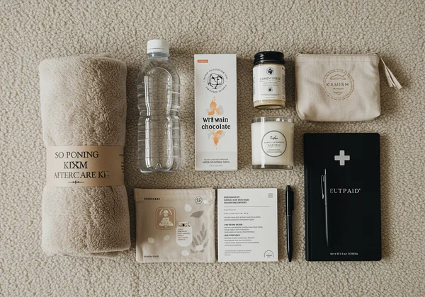 A flat lay of an aftercare kit with comfort items.